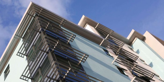 Detail of modern apartment block with aluminium solar louvres